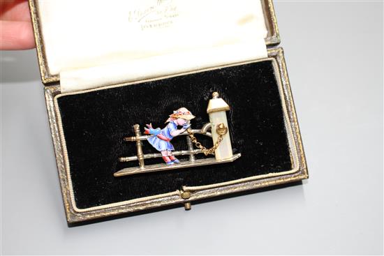 An early 20th century mixed metal, enamel and mother of pearl set Kate Greenaway brooch, in fitted box,